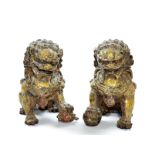 A pair of ferocious guardian foo dogs holding embroidered balls and cubs. Height: 16 cm, 6 1/4".