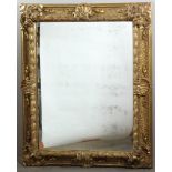 Ornate giltwood framed mirror, 43" x 33 1/2" (opening ), 55 1/2" x 46 1/4" (frame). Provenance: