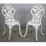 Pair of painted aluminum garden side chairs with rose motif, 34 1/4" H x 16 1/4" W x 15" D.