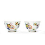 Cups are well potted and raised from straight feet, richly enameled flower-balls around the body.