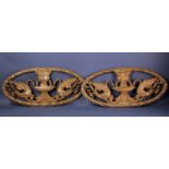 Pair of 1920's decorative wrought iron oval-shaped wall plaques, 24" x 11".