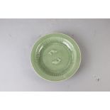 Chinese Longquan celadon green porcelain plate with carved two fish design, 9 3/4" diameter.