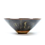 Bowl well potted with gently rounded sides rising from a short straight foot to an everted rim,