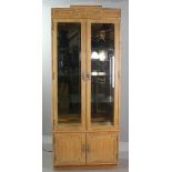 Bamboo-style curio cabinet having beveled glass panels with interior light, 83" H x 34" W x 15" D.