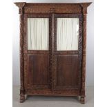 Anglo-Indian ornately hand-carved two-door cabinet, Christies label on interior, 73" H x 55" W x 26"