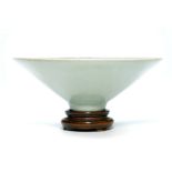 The bowl has deep sides flaring widely from the small, delicate foot, covered inside out with a