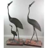 Pair of 19th century Japanese life-size bronze herons, male, and female with chick, signed on necks,