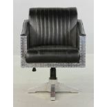 Designer aviator desk chair, riveted aluminum with black leather upholstery, adjustable height,