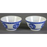 Pair of Chinese blue and white porcelain cups with dragon pendant, 3 1/2" diameter.