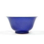 The bowl is covered under a powder-blue glaze. The interior and the base of the bowl are covered