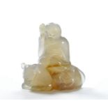 The semi-translucent agate vividly carved into Pindola Bharadvaja riding a crouching tiger with rich