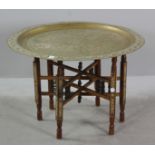 Anglo-Indian hammered brass tray on carved and inlaid stand, 21" H x 31" diameter. Provenance: