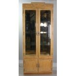 Bamboo-style curio cabinet having beveled glass panels with interior light, 83" H x 34" W x 15" D.