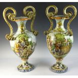 Pair of circa 1910-1920 Capodimonte earthenware urns with serpent handles, 24 1/2" H x 12" W. 1-inch