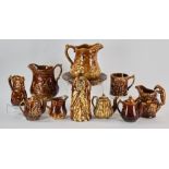 Collection of 19th century Rockingham glazed pottery pieces to include five (5) pitchers, one with