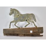 Tin running horse weather vane mounted on old board, vane measures 10 1/4" H x 14" L. Provenance: