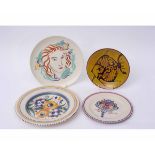 Group of four Poole plates variously decorated with the ZY pattern, a bouquet, deer and a fish