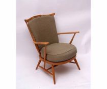 Ercol light elm stick back elbow chair with green upholstered cushions