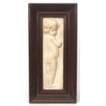 Plaster plaque of a child in oak frame, 43cms x 12cms