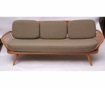 Retro mid-century Ercol light elm day-bed with surf board back, raised on splayed tapering legs,