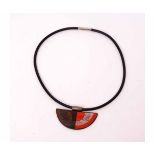 A Designers Guild Brutalist necklace, a Day/Night pendant on a rubber chord choker style necklace,