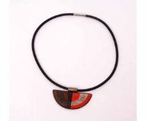 A Designers Guild Brutalist necklace, a Day/Night pendant on a rubber chord choker style necklace,