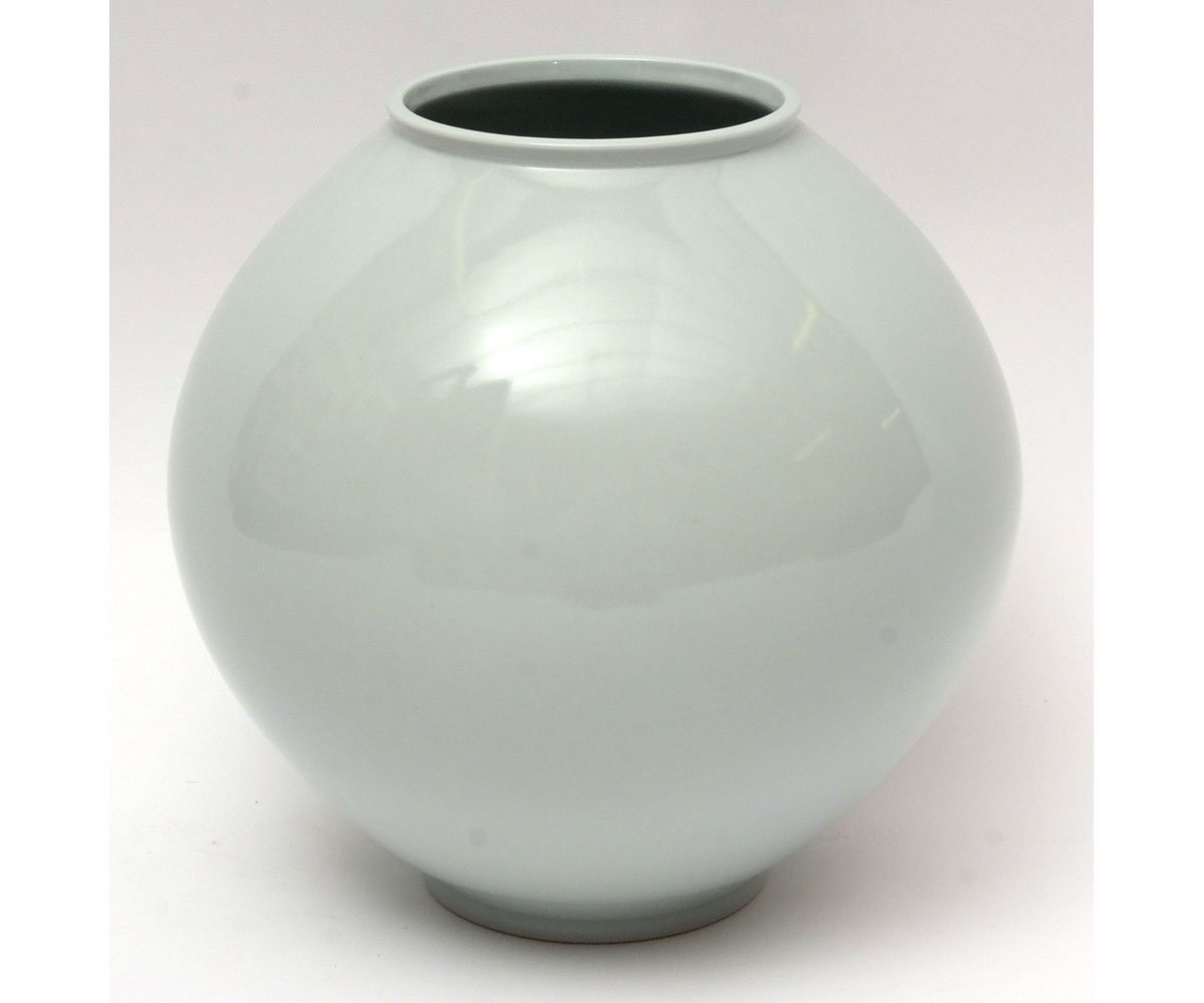 Large Korean studio pottery moon jar in wooden case with a celadon type glaze and signature to base,