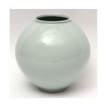 Large Korean studio pottery moon jar in wooden case with a celadon type glaze and signature to base,