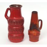 Pair of West German pottery ewers with geometric design on red ground, the base with paper label for