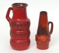 Pair of West German pottery ewers with geometric design on red ground, the base with paper label for