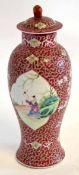 Chinese vase and cover, the pink scroll ground with panels of Chinese figures, 28cms high