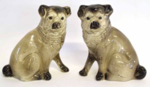 Pair of pottery dogs in a grey ground glaze