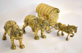 Two brass cast models of shire horses together with a further model of a gipsy caravan and horse (3)