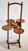 Early 20th century oak framed folding cake stand with four circular stands, 95cms tall