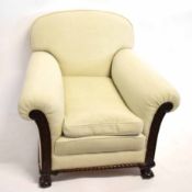 Pair of early 20th century mahogany framed club armchairs with carved fronts and cream upholstery,