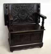 Early 20th century oak framed metamorphic monk's bench with carved top and lift up lid and three
