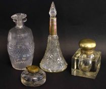 Cut glass inkwell with plated cover together with two decanters, one with silver rim, one further