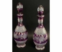 Pair of lead crystal decanters and covers, hobnail cut with engraved decoration on a purple ground