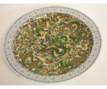 Modern Chinese porcelain charger with famille vert decoration of dragons within a blue border, 43cms