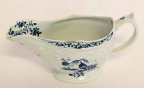 Large Lowestoft sauce boat circa 1765, the body crisply moulded with trailing flowers, bordering a