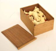Box containing a set of stained bone chess pieces with damage throughout