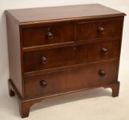 19th century mahogany two over two full width drawer chest with turned knob handles, raised on