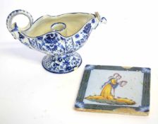 Delft tile decorated in polychrome with an angel, together with a further Delft pottery jug with