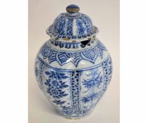 Delft lobed vase and cover decorated in a floral style, the cover with similar decoration and