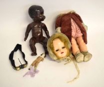 Vintage plastic bodied doll (dismantled) with an overcoat, together with a further plastic black