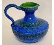 West German type pottery ewer, the oval body in a blue and green glaze with strap handle, 23cms high