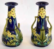 Pair of Minton secessionist two-handled vases on a blue ground decorated in yellow flowers, with