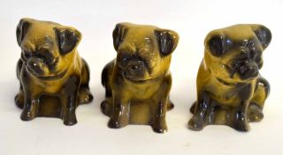 Collection of three pottery dogs in grey and black glazes