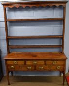 Late 18th/early 19th century oak dresser, the top fitted with three open shelves and shaped top, the