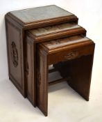 Early 20th century Oriental hardwood set of three nesting tables with heavily carved Oriental scenes